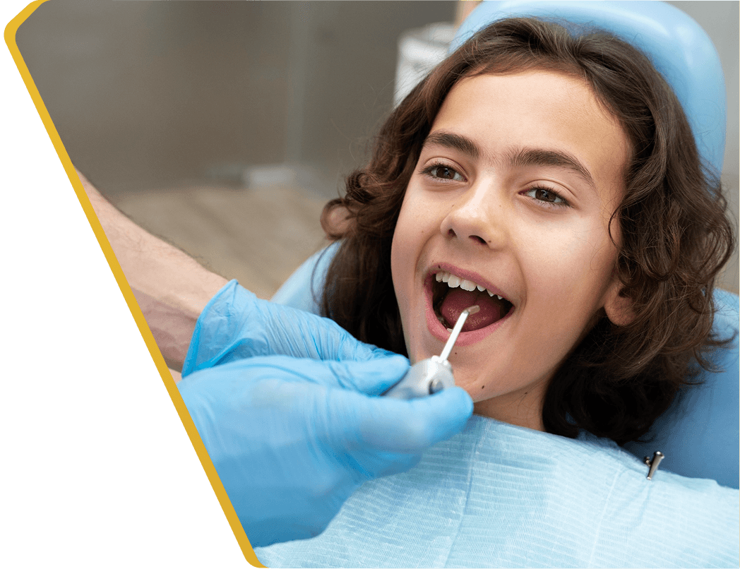 A child smiling after getting protective dental sealants at Dentistry at Millennium Park in Chicago