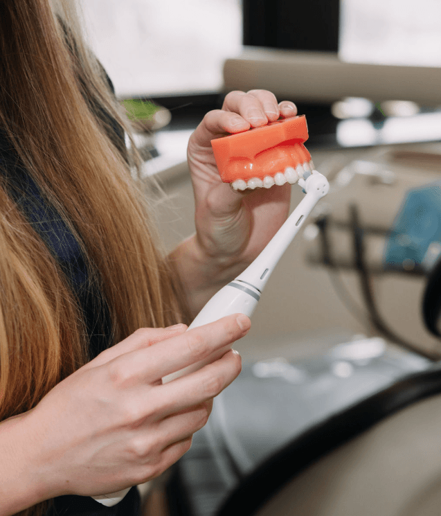 A dental hygienist cleaning a patient's teeth in Chicago