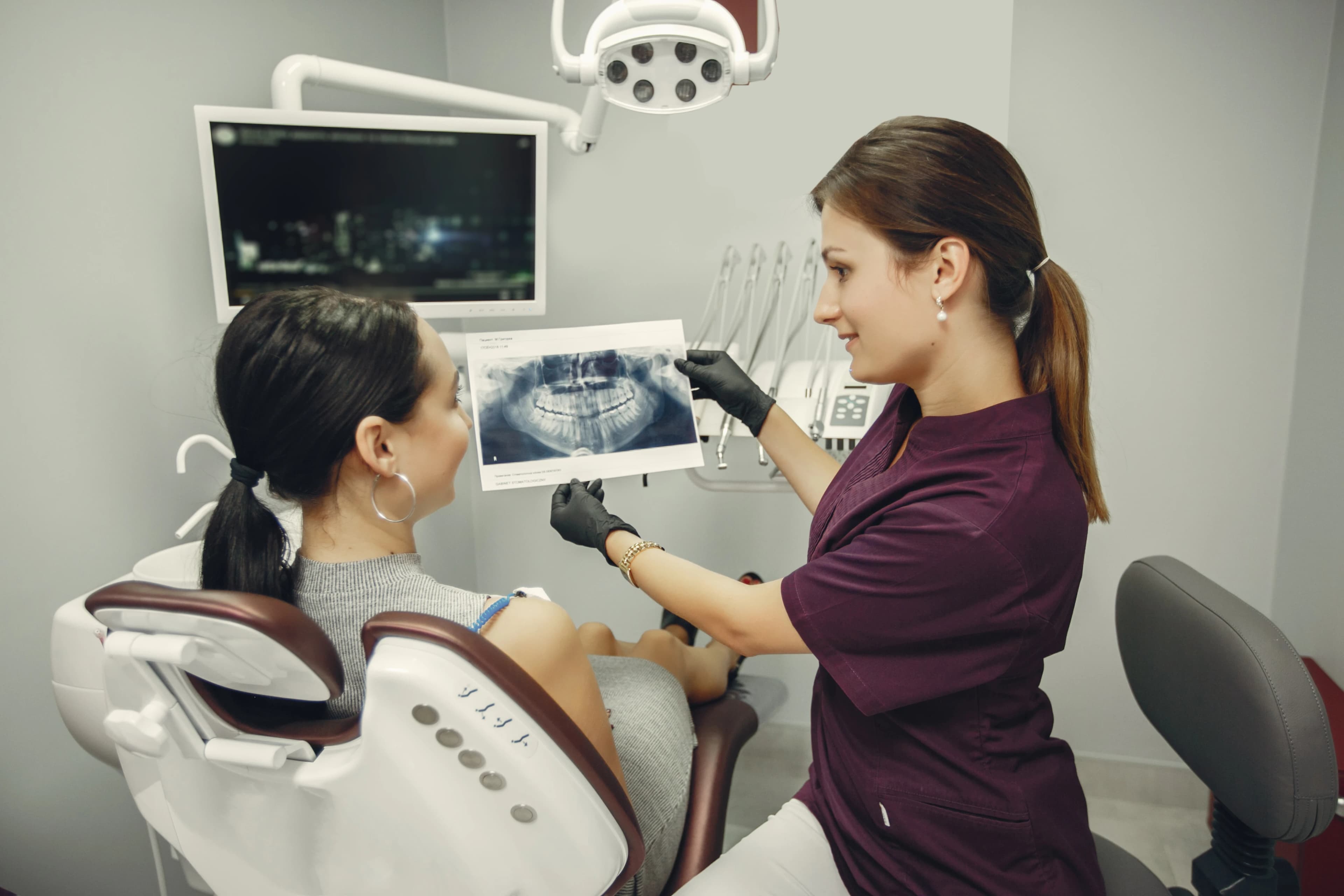 A dentist reviewing digital dental X-rays on screen at Dentistry at Millennium Park in Chicago