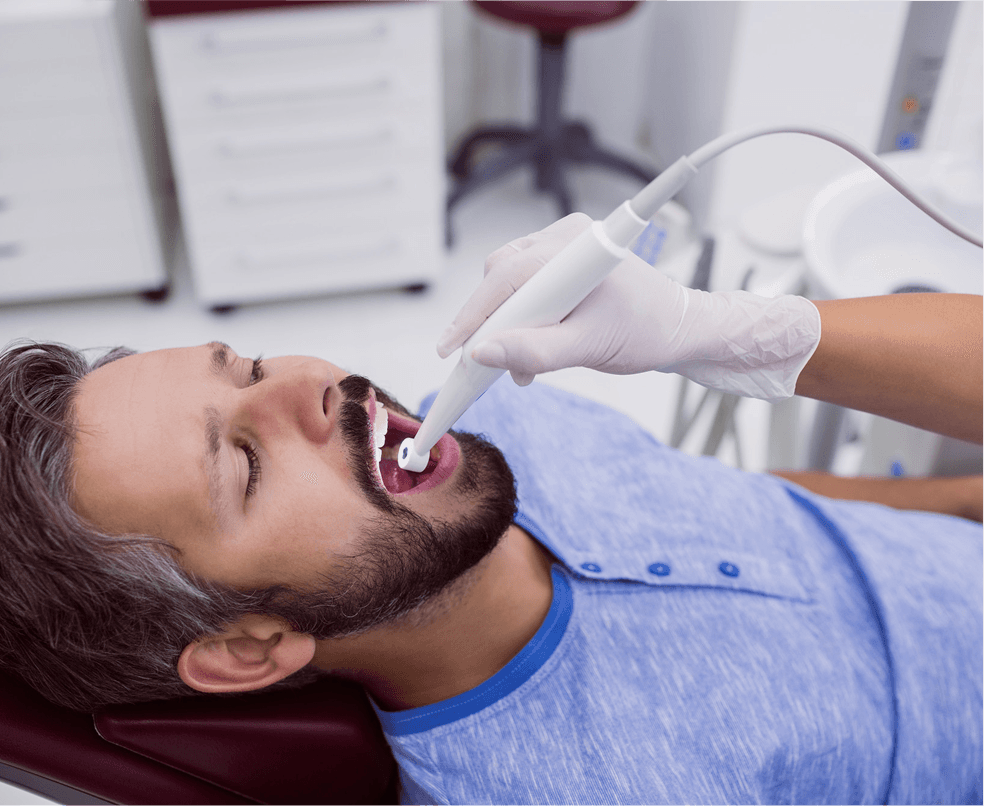 A dentist showing a patient real-time intraoral camera images on screen at Dentistry at Millennium Park in Chicago