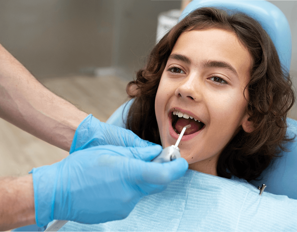 A child smiling after getting protective dental sealants at Dentistry at Millennium Park in Chicago