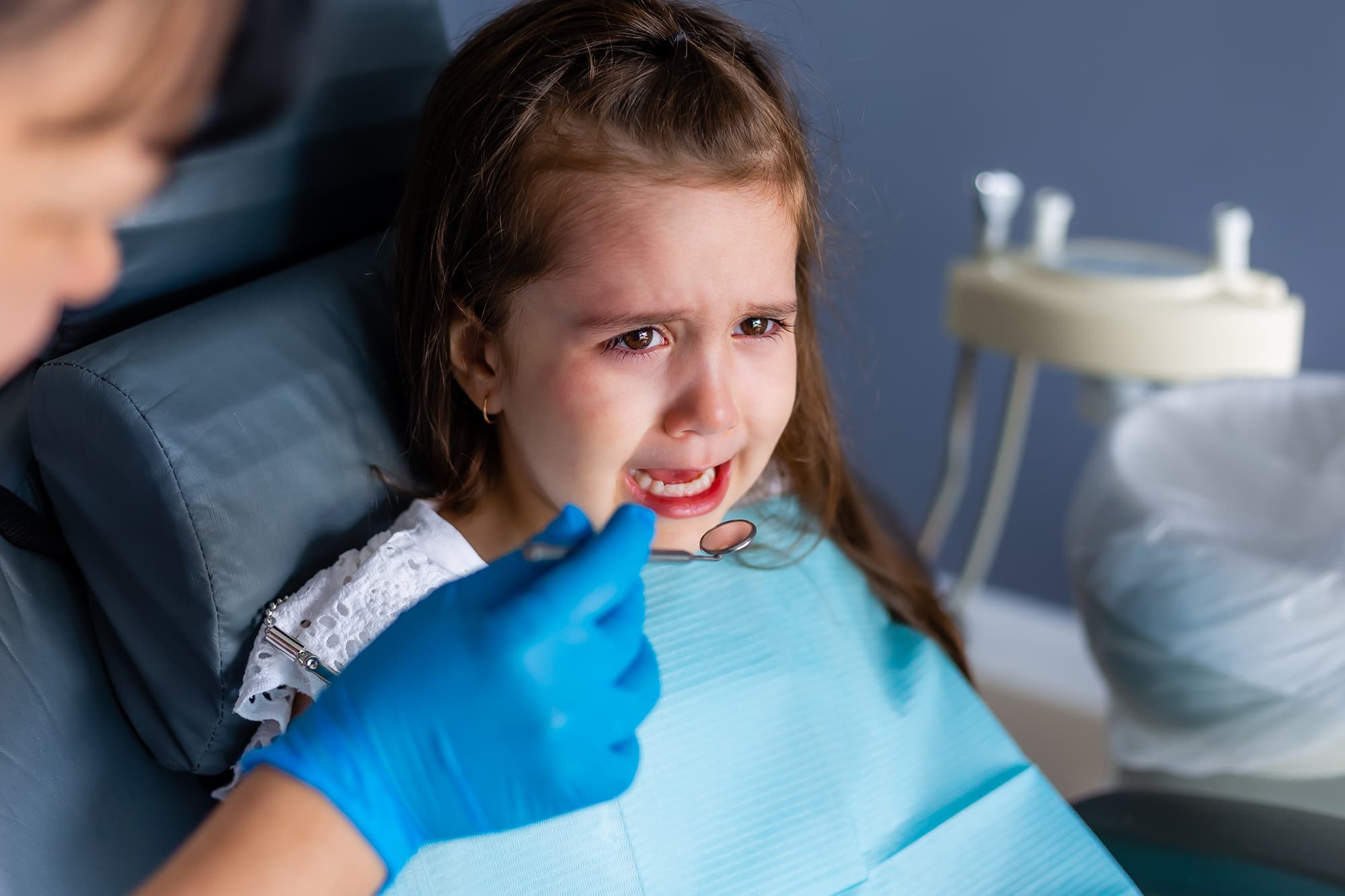 A caring dentist comforting a child at Dentistry at Millennium Park in Chicago