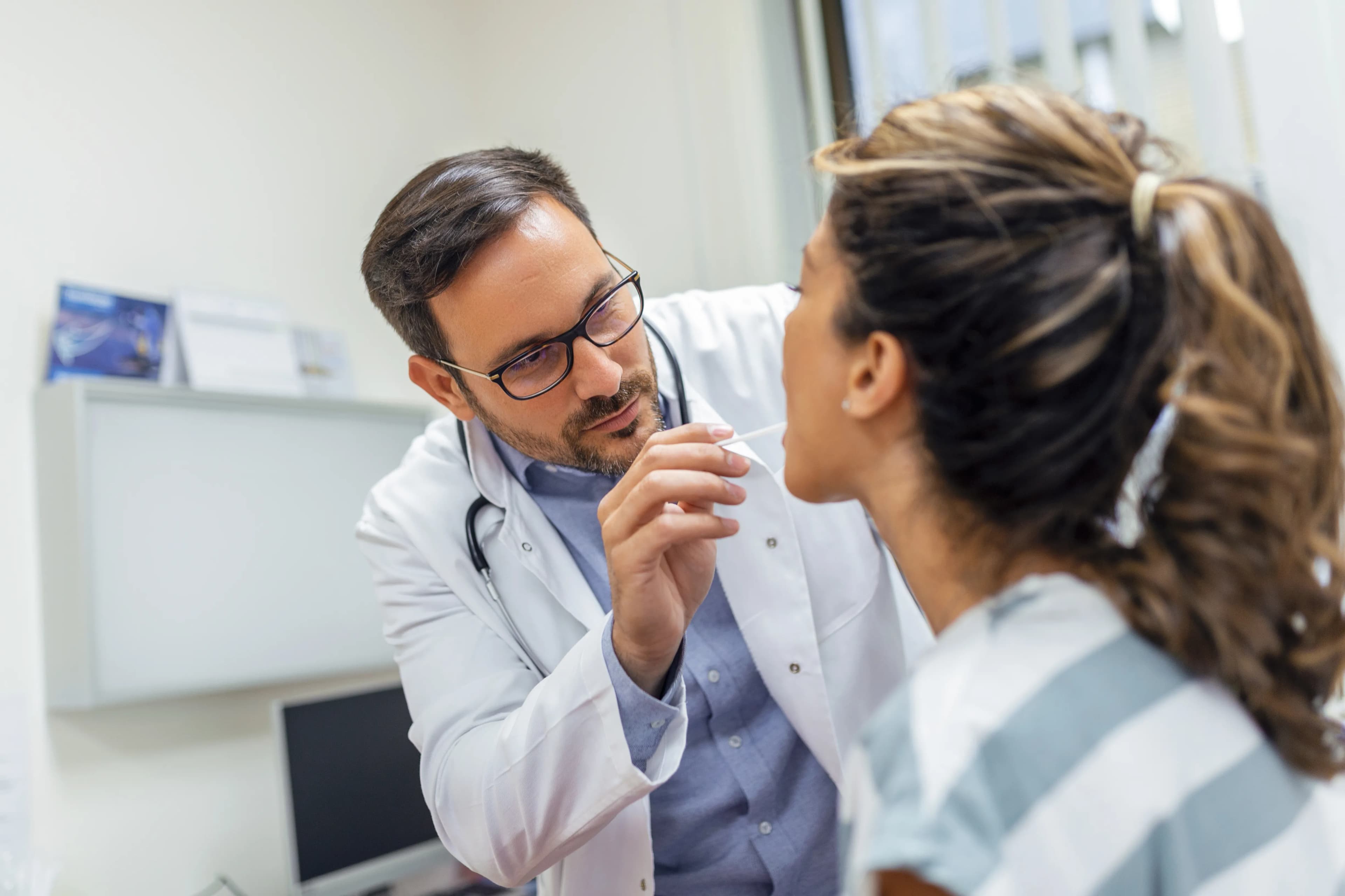 A dentist performing a gentle oral cancer screening at Dentistry at Millennium Park in Chicago