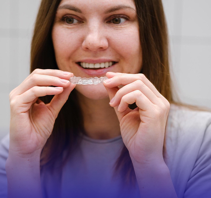 A patient placing a clear aligner tray