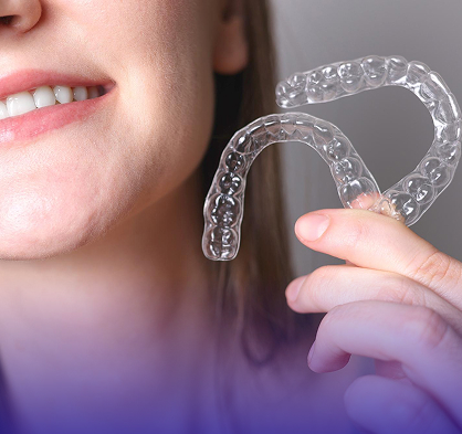 A patient placing a clear aligner tray