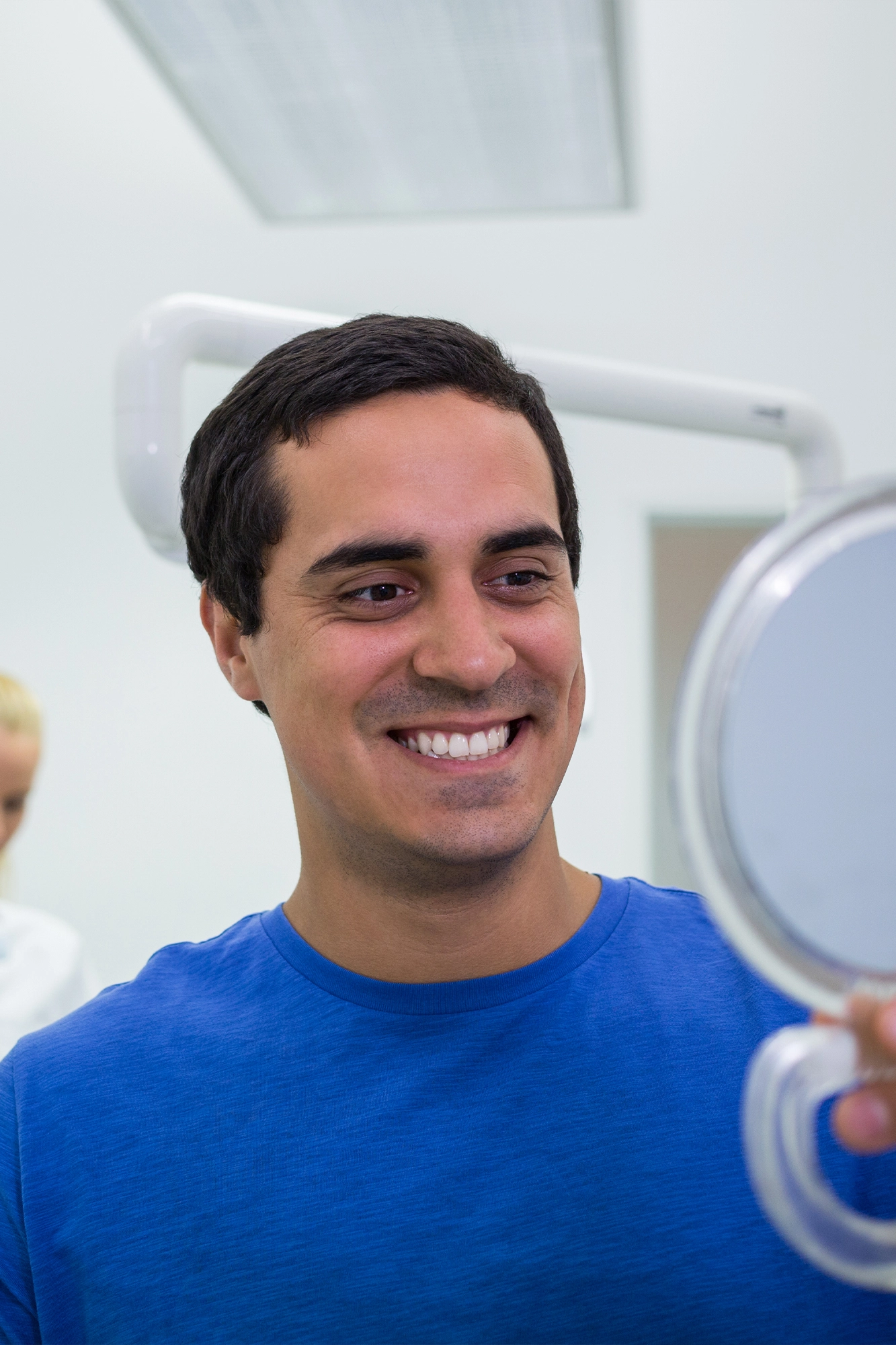 A dentist applying tooth-colored bonding resin to a tooth
