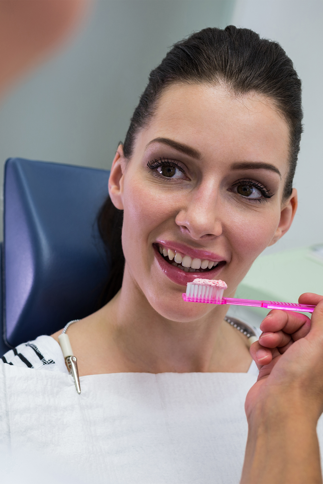 A dental hygienist cleaning a patient's teeth