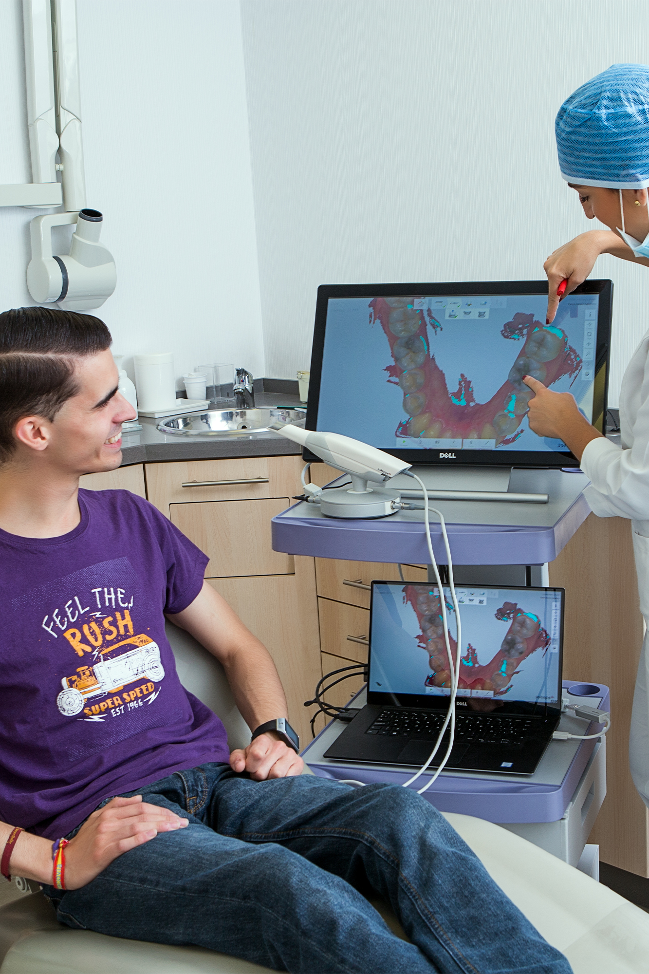 A dentist showing a patient real-time intraoral camera images on screen at Dentistry at Millennium Park in Chicago