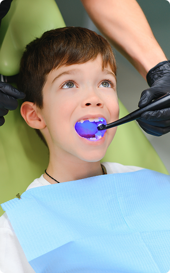 A protective fluoride varnish being applied to a child's teeth