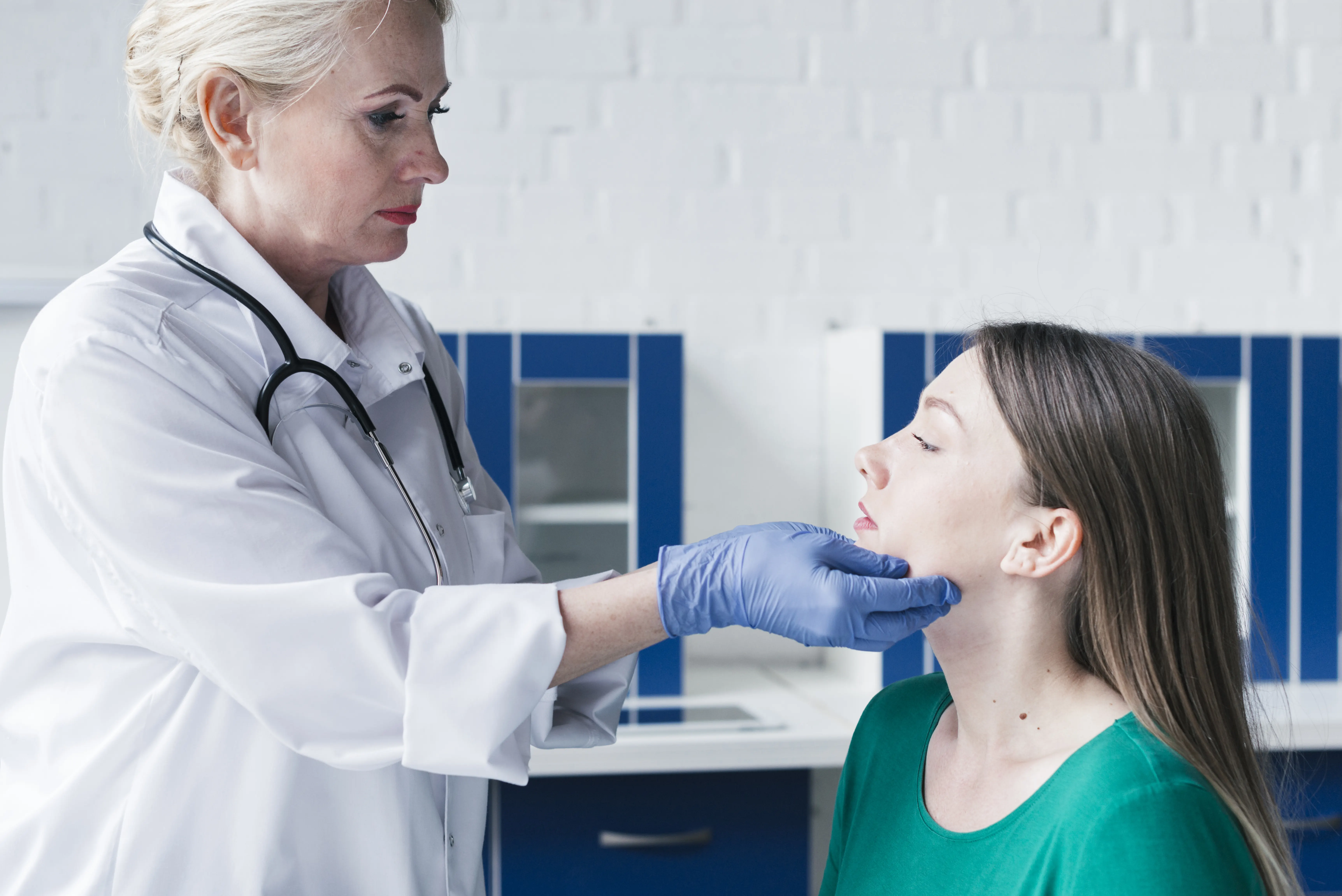 A dentist examining a patient's mouth and soft tissues